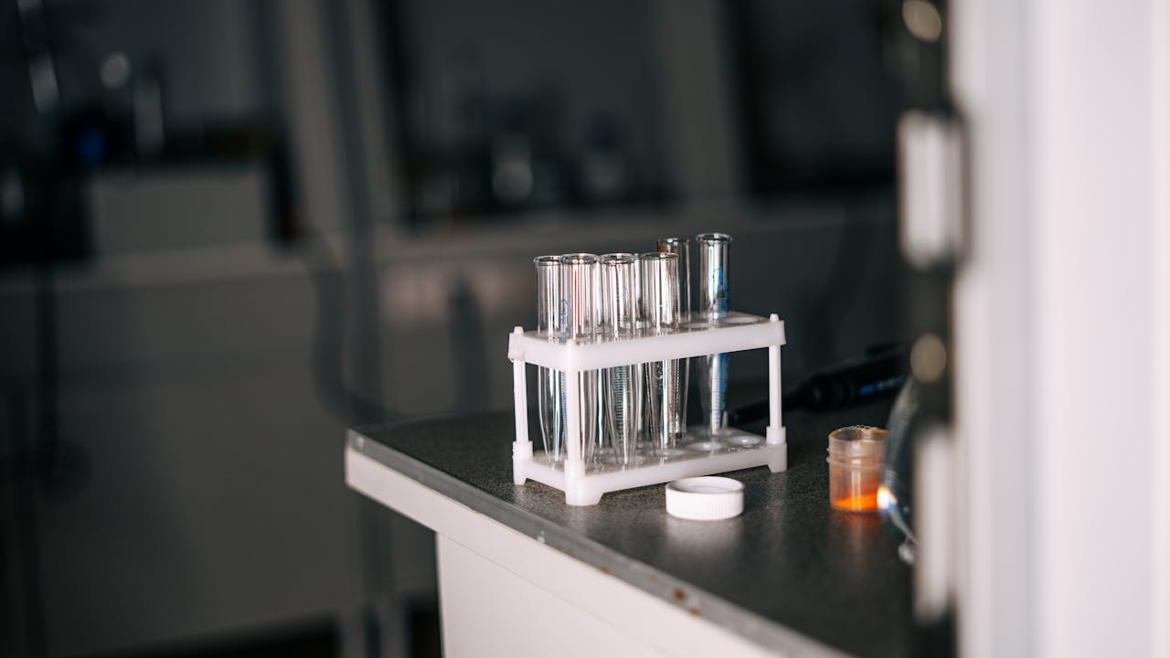 Close-up view of laboratory test tubes and equipment on a lab bench, enhancing scientific exploration.